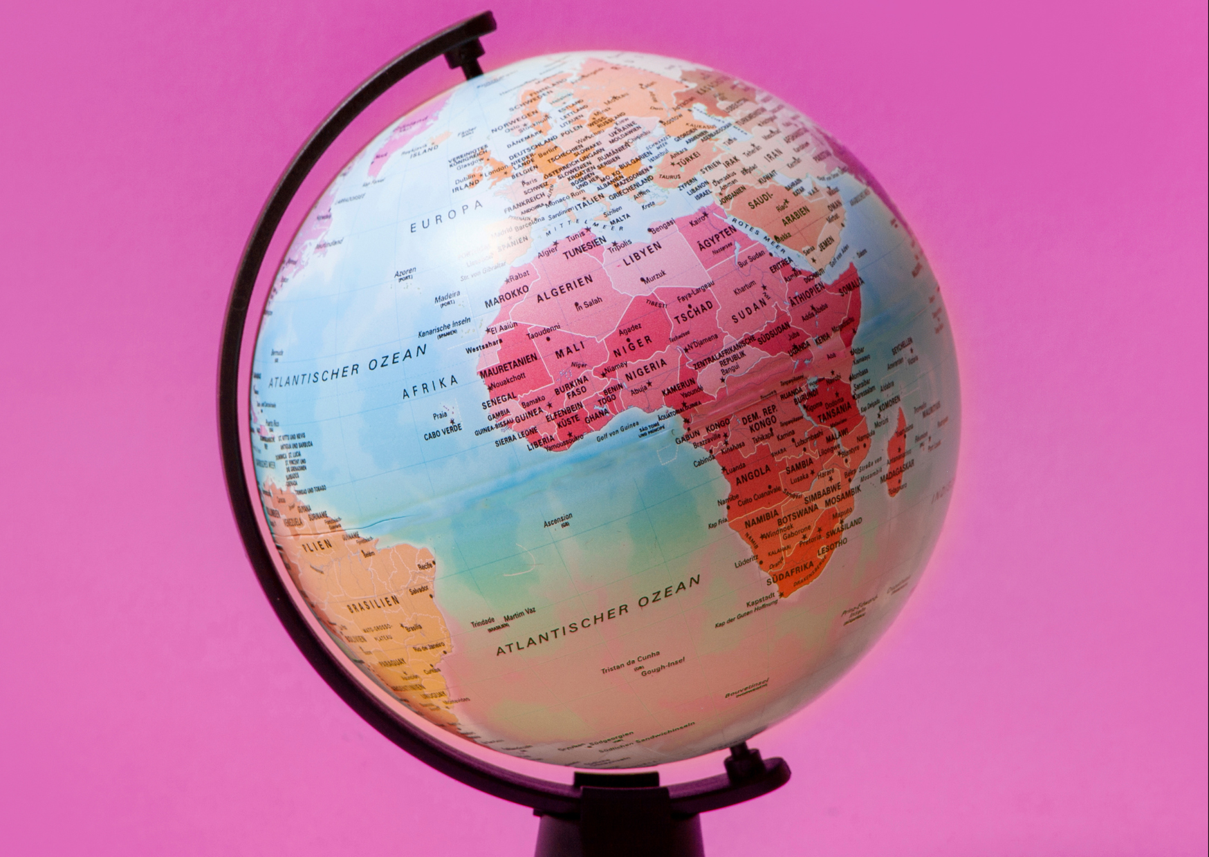 A globe in pink background