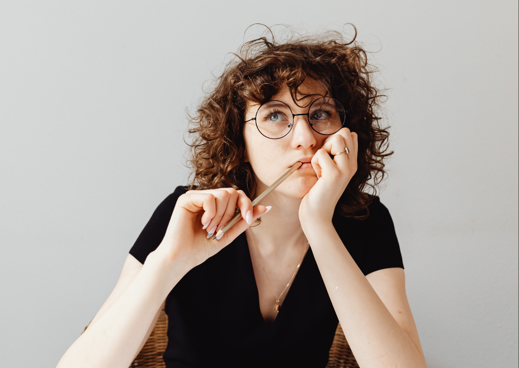 Lady wearing glasses with thinking pose